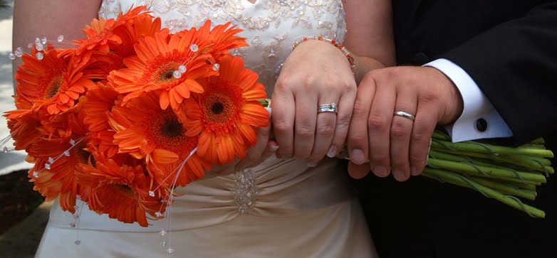Vibrant orange daisy wedding bouquet with long stems