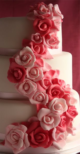 Elegant round five tier white wedding cake with pale pink sugar roses