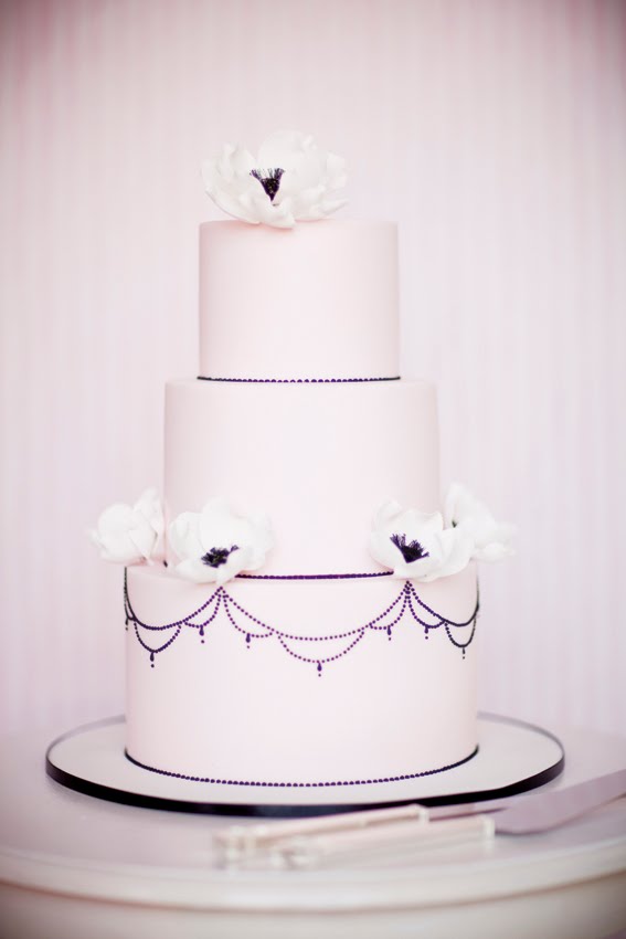 Light pale pink three tier wedding cake with anemones