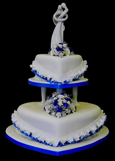White heart shaped wedding cake with blue trimming Ivory heart shaped
