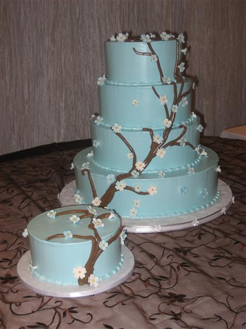 Four tier round wedding cake in tiffany blue with white cherry blossoms