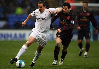 Kevin Davies of Bolton Wanderers and Cesc Fabregas of Arsenal battle for the ball