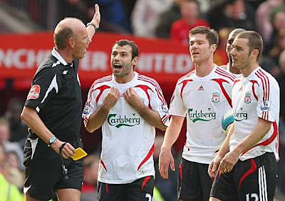 Javier Mascherano of Liverpool protests after being shown a red card by referee Steve Bennett for a second bookable offense just prior to half-time.