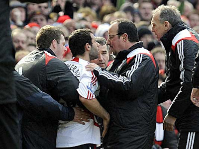 Liverpool manager Rafael Benitez tries to calm midfielder Javier Mascherano (center) after he was sent off against Manchester United.