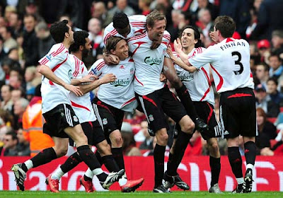 Peter Crouch of Liverpool is mobbed by teammates as he celebrates scoring the opening goal