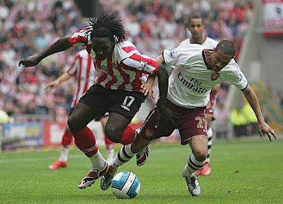 Kenwyne Jones of Sunderland and Gael Clichy of Arsenal challenge for the ball during their Premier League match at the Stadium of Light in Sunderland, England.