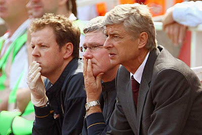 Arsene Wenger, manager of Arsenal (right), calmly watches the game between Arsenal and West Brom.