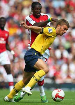 James Morrison of West Bromwich Albion battles for the ball with Emmanuel Adebayor of Arsenal