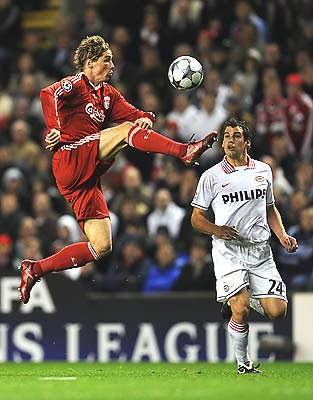 Fernando Torres of Liverpool leaps to win the ball.