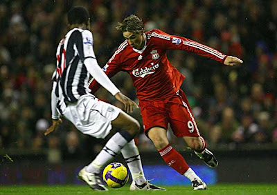 Fernando Torres of Liverpool looks for a way past Ryan Donk of West Bromwich Albion.