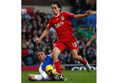Stephen Warnock of Blackburn Rovers slides in on Liverpool's first scorer Yossi Benayoun