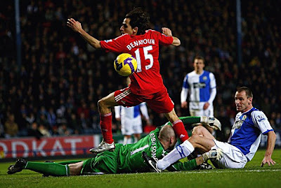Yossi Benayoun of Liverpool gets through clear on goal but misses past keeper Paul Robinson and Andre Ooijer of Blackburn Rovers. Liverpool, though, won the game 3-1.