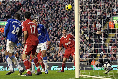 Everton defender Joleon Lescott (third left) scores the opening goal past Liverpool goalkeeper Jose Reina (right).