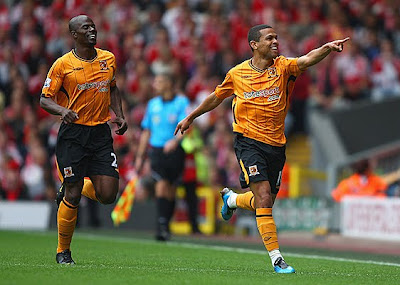 Geovanni (right) of Hull City celebrates scoring his team's first goal with teammate George Boateng during their match against Liverpool at Anfield.