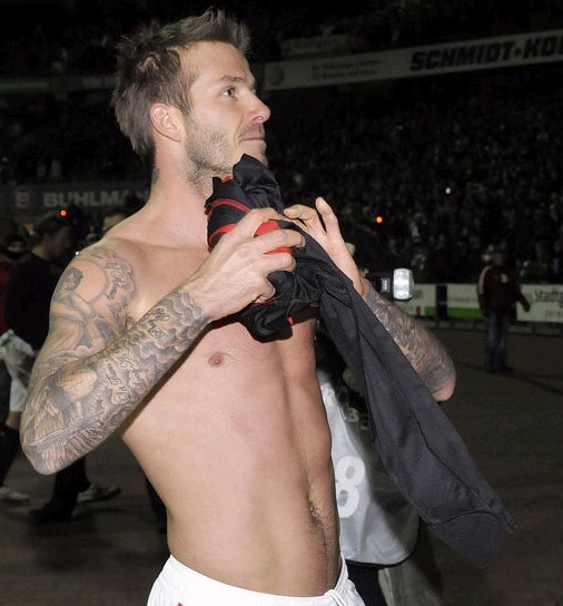 art soccer tattoo David Beckham with tribal tattoo on his arm, beckham is an 