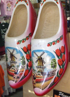 giant wooden shoes with windmills painted on them