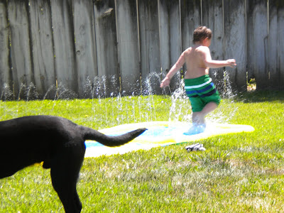 Brian running down the slip-n-slide with Dagan's butt in the foreground
