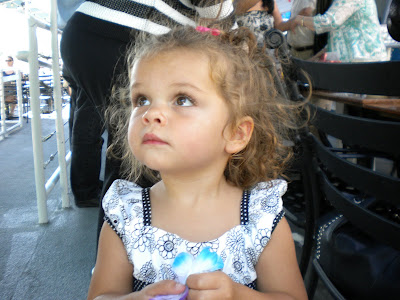 18 month old Caitlyn, curly hair and cute face in her pretty party dress