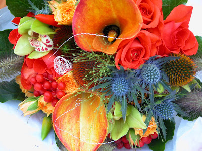 We used Naranga Roses Mango Calla Lilies Eryngium Thistles Echinops and We used Naranga Roses Mango Calla Lilies Eryngium Thistles Echinops and