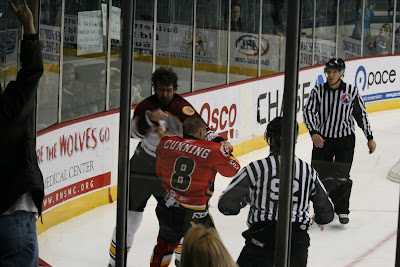 Credit: Jane Rickard,Boris Valabik defends Wolves goalie from a bit of interfearence during the third period