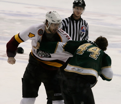 Credit:Jane Rickard, Valabik/Crombeen round 2 third period, Crombeen barley hangs on after the first few seconds. The linesman looks on deciding to when to call the *fight*.