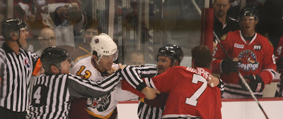 Credit: Jane Rickard, Andre Deveaux welcomes Ice Hog Evan Brophey to the AA