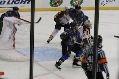 Credit:Jane Rickard, everyone is watching the puck work down the ice.