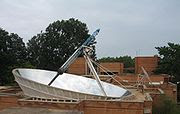 The Solar Bowl in Auroville, India, concentrates sunlight on a movable receiver to produce steam for cooking.