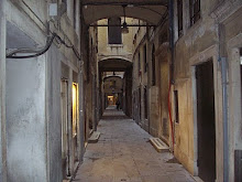 Ancient grotesque alleyways between buildings in Venice city.