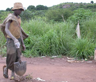 A child miner heads to work in the pits.