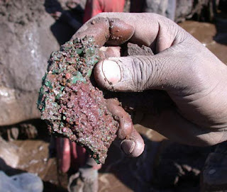 Copper ore, scrabbled out of the dirt by children.