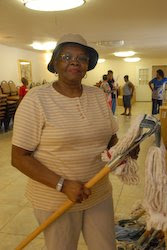 Eva Bosley checks out one of the mops, which was just delievered by World Vision to Greater First Baptist Church in Houston, Texas.