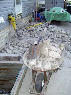 Rubble from the back steps in the process of being cleared.