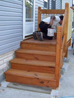 Staining the pickets/slats on the deck.