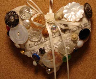 Button Heart has old collectible glass and shell buttons sewn to it.