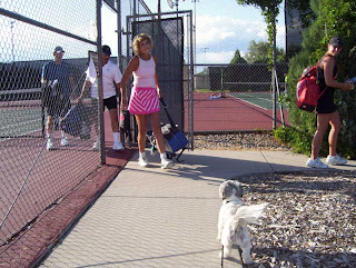 Sandy's dog Spike greets the players upon exiting the fence.