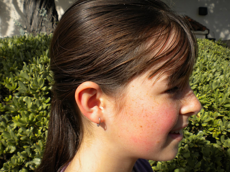 Here's a view of a newly pierced lobe with it's new hoop. title=
