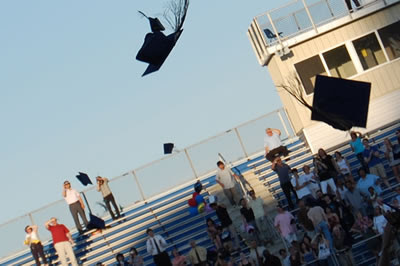 Graduation caps tossed into the air.