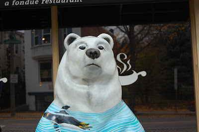 Sculpture of a bear in front of a restaurant.