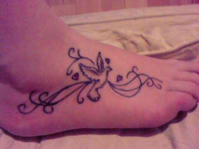 Dove and hearts tattoo on foot