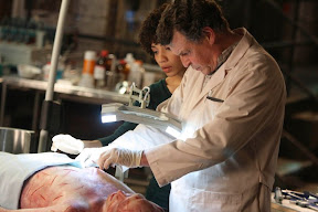 FRINGE: Walter (John Noble, R) and Astrid (Jaskia Nicole, L) examine a man who fell to his death from the Massive Dynamic building in the FRINGE episode The Dreamscape