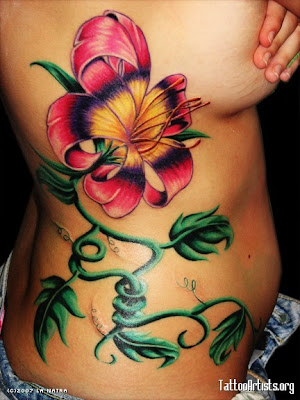 flower tattoos on side of hand. flower back tattoos. lower ack