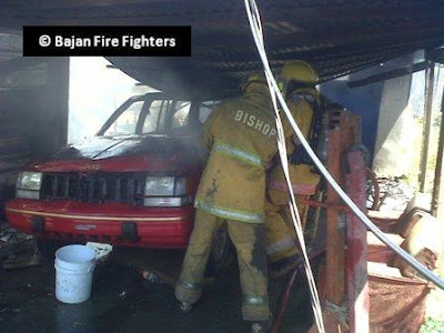 Firefighters extinguishing vehicle
