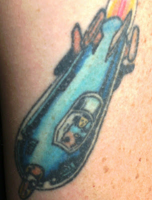 The tattoo represents Superman as a child fleeing the exploding planet of The tattoo represents Superman as a child fleeing the exploding planet of