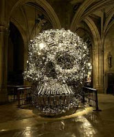 A huge skull crafted out of aluminum pots and pans