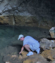 Karen making a wish in Waiwhakaata (pool of mirrors) at the base of Ruatapu Cave