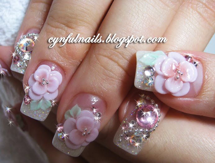 Acrylic nails. White glitter on the tips. Huge gems and pink florals!