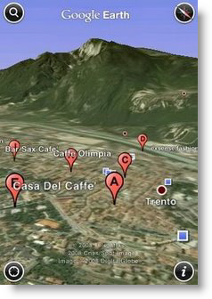Google Earth-Ansicht von Trient. Rote Pinnadeln markieren Unternehmen in der Nähe des eigenen Standorts. Im Hintergrund ist ein Berg zu erkennen.