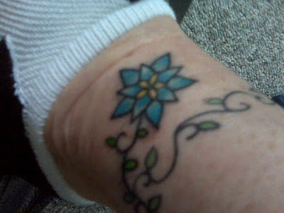 Melissa's mom's tattoo. She previously had the vine on her arm, 