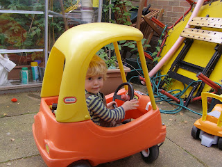 Alex driving his red and yellow car